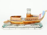 a small wooden boat with a bottle on top of it