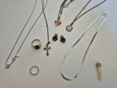 a lot of necklaces and rings on the table