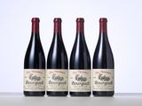 three bottles of red wine are lined up on a table
