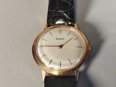 an image of a close up of a wrist watch on a table