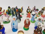 many figurines of different sizes and colors on the table