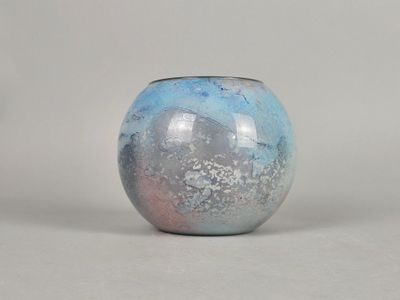 a blue and pink vase sitting on a white surface