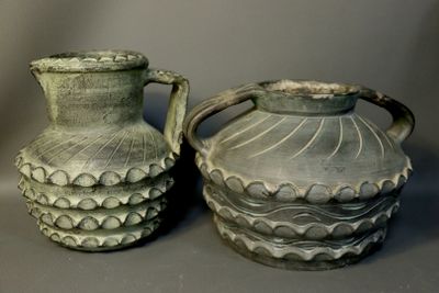 two vases sitting next to each other on a table