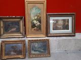 a lot of framed pictures on a ledge in a room