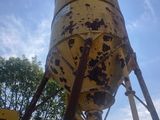 a tall yellow tower with a clock on it