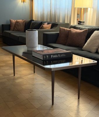 a living room with a couch, coffee table, and lamp