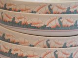 four plates stacked on top of each other on a table