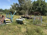 a lot of junk in the grass near a fence