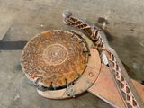 a rusted metal object on the ground next to a pair of scissors