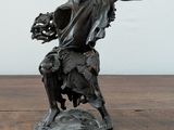 a statue of a man with a dog on a table