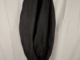 black jacket hanging on a hanger against a white backdrop