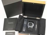 a black box with a watch and a pen in it