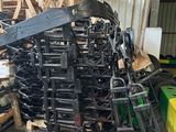 a pile of chairs and other items in a warehouse