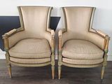 pair of upholstered chairs with upholstered arms and legs