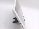 a white tablet computer sitting on top of a white table
