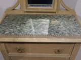 a dresser with a mirror on top of it