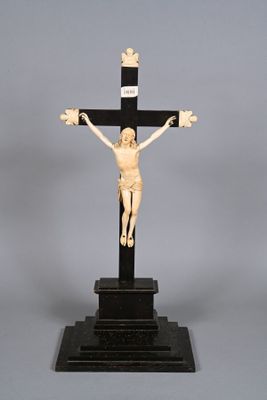 a statue of jesus on a cross on a stand