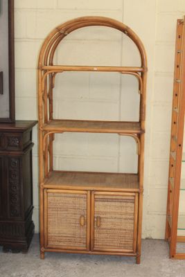 two shelves and a cabinet in the corner of a room