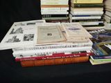 many books stacked on top of each other on a table
