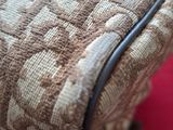 a close up of a piece of luggage on a red surface