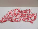an image of a red and white floral shirt on a white table