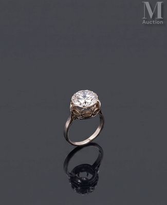 an engagement ring with a round brilliant cut diamond set in 18k white gold
