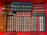 many books in a red box on the shelf