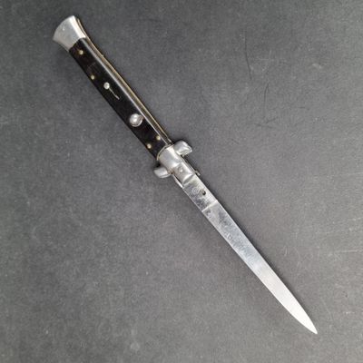 a close up of a knife laying on top of a table