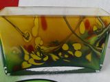 a glass box that has a yellow and green design on it