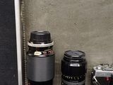 many different types of cameras and lenses in this case