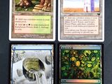 four different cards are shown on a table with a clock tower in the background