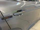 a close up of a car door handle with a sticker on it