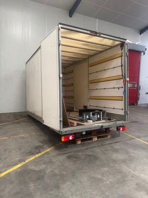 a large white truck that is parked in a garage