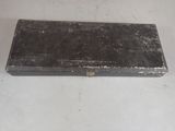 an old black box sitting on a white surface