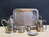 a silver tray with a silver tea set and a silver tray with a silver teapot