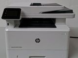a white printer sitting on top of a white table