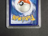 a pokemon card in a plastic holder on a table
