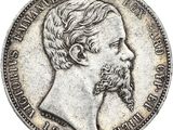 une pièce d'argent représentant le visage d'un homme barbu