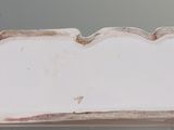 a white object with holes in the middle of it