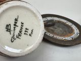 a small cup with writing on it sitting on a table