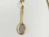 an image of a tennis racket and chain on a white surface