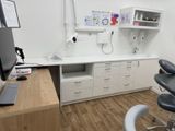 a desk with a computer and a chair in a room