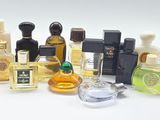 many different types of perfume bottles on a white surface