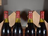 three bottles of wine are sitting in a box on a table
