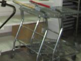 a metal cart with a glass top in a kitchen