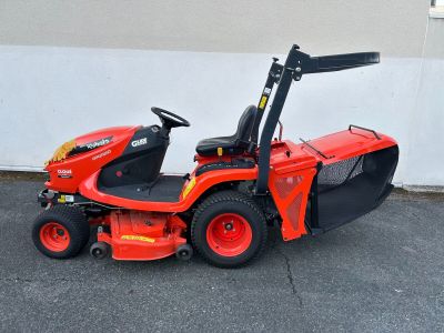 an image of a ride on lawn mower parked in a parking lot