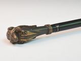 a cane with a lion head on it sitting on a table