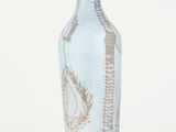 a blue vase with a design on it on a white surface