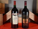 two bottles of wine sitting next to each other on a table