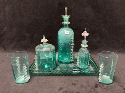 un plateau en verre sur lequel sont posés une bouteille et des verres